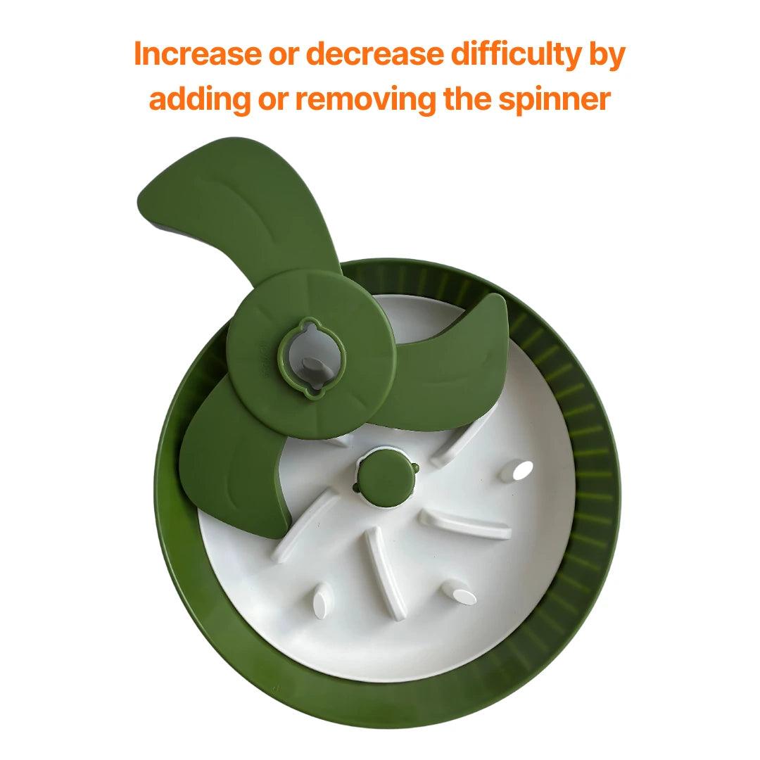 Image description: Slow Feeder with rotating spinner.
Text on image: Increase or decrease difficulty by adding or removing the spinner.