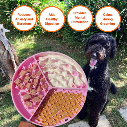 Image description: Dog with tongue out, looking at the slow feeder lick mat being held in a person's hand. Slow feeder lick mat is filled with peanut butter, natural yoghurt and pieces of meat.
Text on image: Reduces anxiety and boredom, Aids healthy digestion, Provides mental stimulation, Calms during grooming.